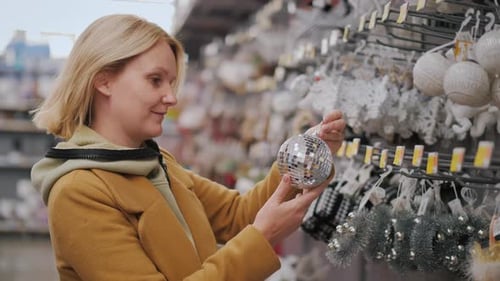 Woman Shops for Christmas Ornaments at Retail Store