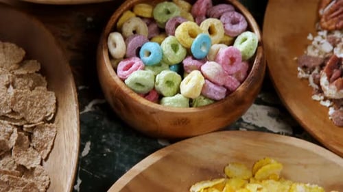 Colorful Assorted Cereals in Wooden Bowls for Breakfast