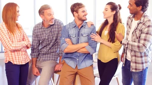 Business colleagues interacting with each other in office
