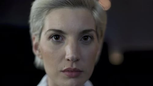 Blonde Woman Stares Intently in Close Up Shot