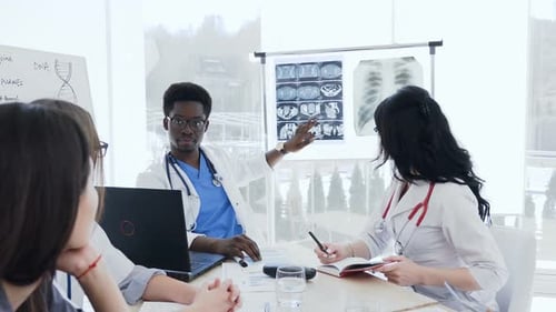 Medical Professionals Collaborating During Meeting in Modern Office