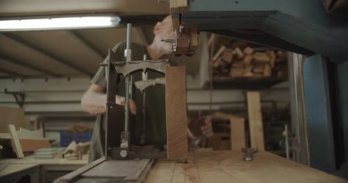 Man Uses Small Band Saw Cutting Wood