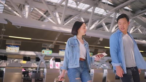 Asian beautiful passenger traveler couple walking in airport terminal to boarding gate to airplane.