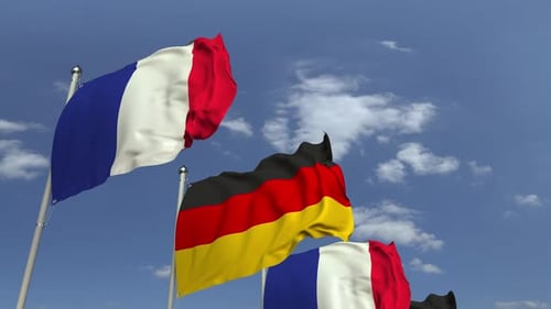 Waving Flags of Germany and France Against a Clear Sky