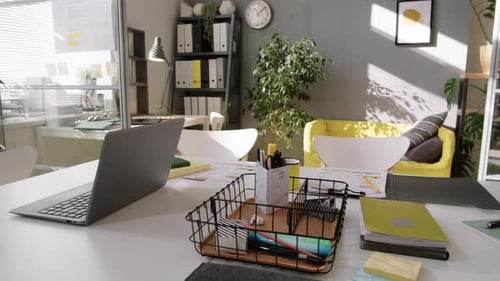 Desk wit Office Supplies and Laptop