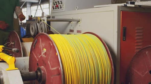 Machinery Winding Yellow Cables onto Large Spool