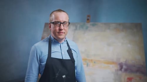 Man Standing in Front of Painting