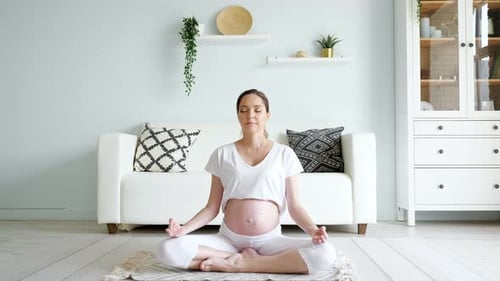 Pregnant Woman Meditating at Home, Full Shot