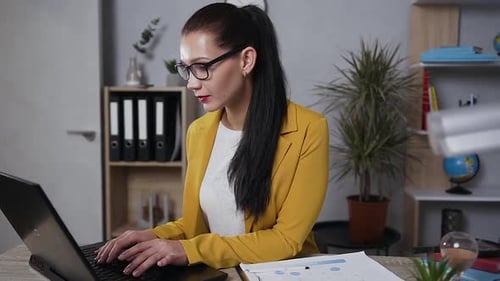 Brunette Business Lady in Trendy Jacket which Working in Home Office on Computer