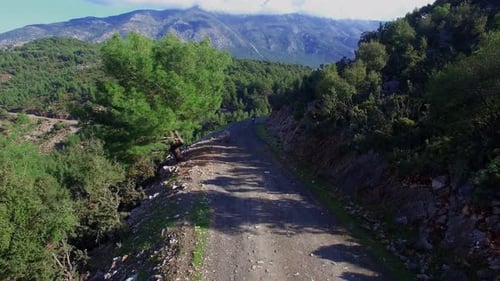 Motorcyclist Rides Through Rural Mountainous Terrain