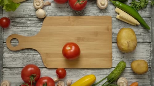 Fresh Vegetables with Tomato Placed on Cutting Board