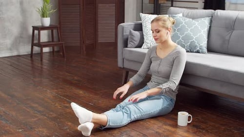 Woman Relaxing at Home Listening to Music