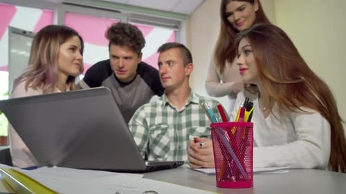 Group of College Students Discussing Assignment, Studying Together