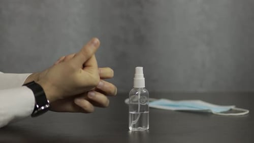 Close Up of Hands Applying Sanitizer at Work