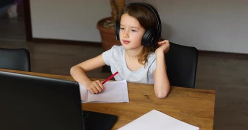 Girl Learning Online at Home with Headphones