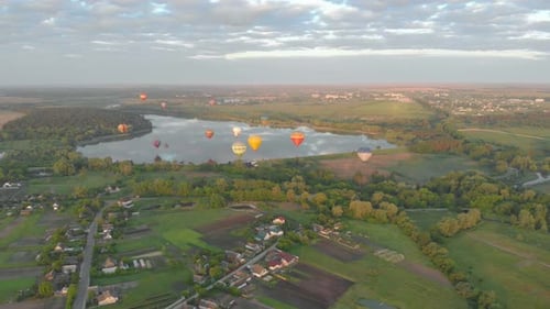 Hot Air Balloons Floating Over Lake at Sunrise
