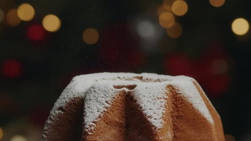 Powdered Sugar Being Sprinkled on a Cake