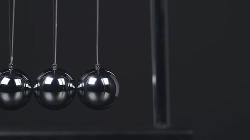 Swinging Newtons Cradle Momentum and Energy Demonstration