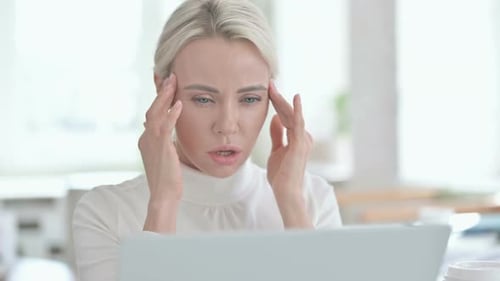 Portrait of Young Businesswoman Having Headache in Office