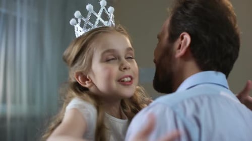 Cute Little Girl in Princess Crown Dress Hugging Father, Tender Relations, Party