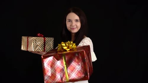 Woman Smiling Holding Two Christmas Gifts