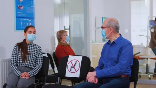 Patients Social Distancing in Bright Dental Clinic Waiting Room