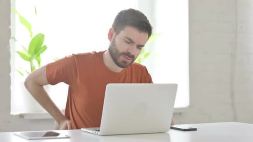 Man Working at Laptop Having Back Pain