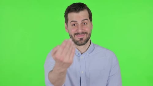 Portrait of Man Pointing at the Camera and Inviting Green Screen