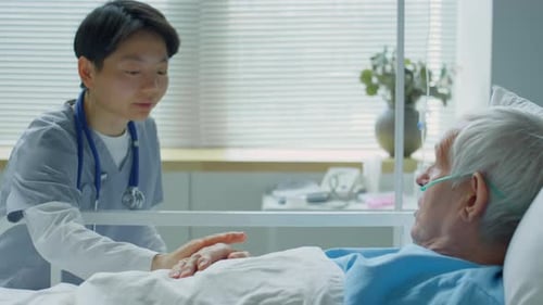 Young Doctor Speaking With Senior Patient