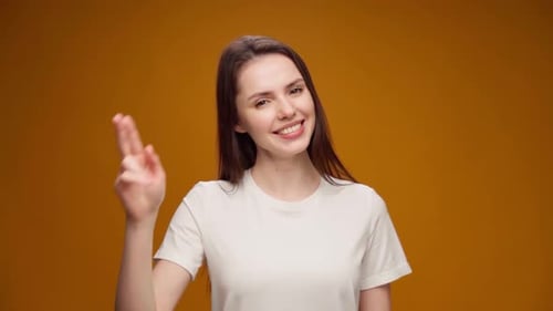 Happy Woman Smiling and Holding Up Fingers