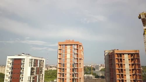 Aerial view of tall residential apartment buildings under construction. Real estate development.