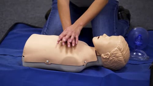 Adult Training CPR Compressions on Medical Dummy