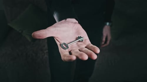 Key Hidden in the Fist of Male Hand