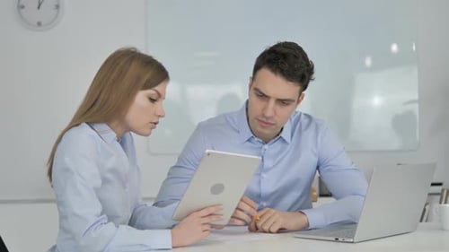 Young Professionals Collaborating in Bright Office Setting