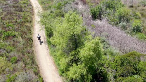 Aerial View of Riding Mountain Bike in a Small Singletrack Trail in the Mountain
