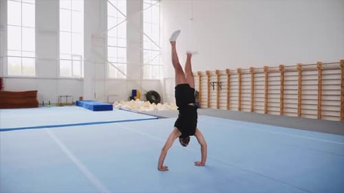 A Sportsman Is Doing a Cartwheel and a Double Back Flip and Lands, Steadicam