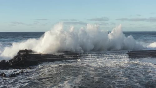 Crashing Waves on Rocky Pier, Coastal Scenery
