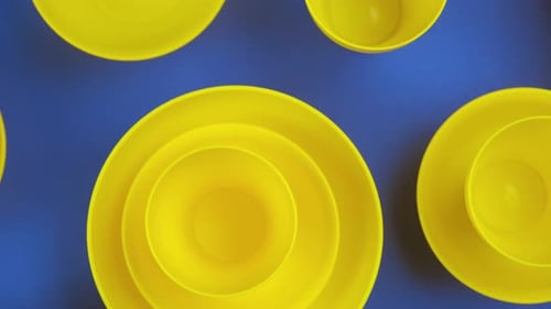 Yellow Bowls and Plates on Blue Background