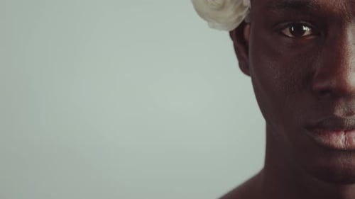 Elegant Person With Flower in Hair Close Up