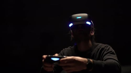 Man Wearing VR Headset Playing Video Games
