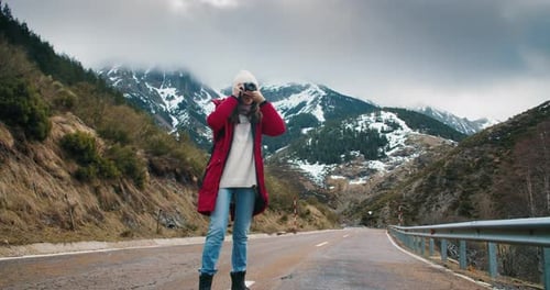Traveler and Professional Photographer Walks on Empty Mountain Road Shot Picture