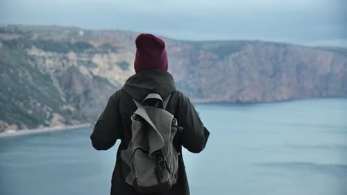 Back View Winner Backpacker Female Raising Hands Celebrating Victory on Peak Mountain Sea Landscape
