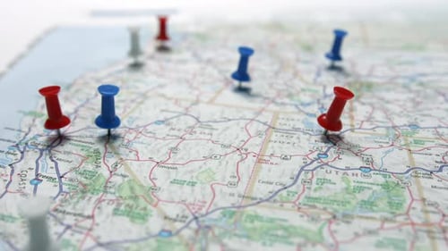 Marked Travel Map with Red and Blue Pushpins