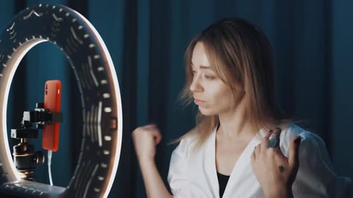 Blonde Mature Woman Beauty Blogger Combs Her Hair in Front of Ring Light