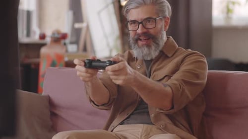 Bearded Man Relaxing While Playing Video Games