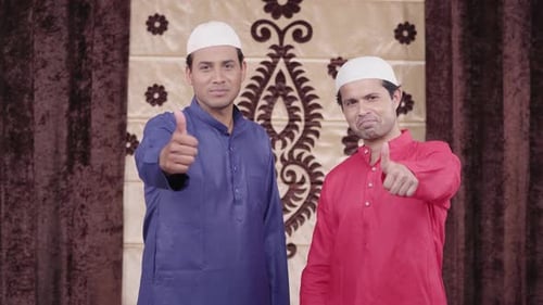 Two Men in Traditional Clothing Giving Thumbs Up