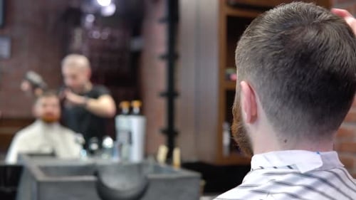 Barber Styling Man's Hair With Hair Dryer