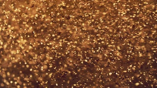 Abstrakte goldene Partikel mit verschwommenen defokussierten Bokeh-Bewegungen, Chaos, Schneeflocken