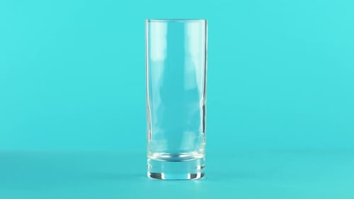 Glass Filled with Yellow Juice on Blue Background