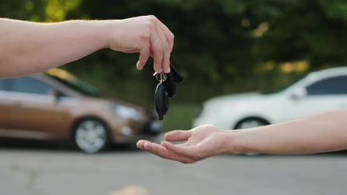 Man Gives a Car Key To the Other Man